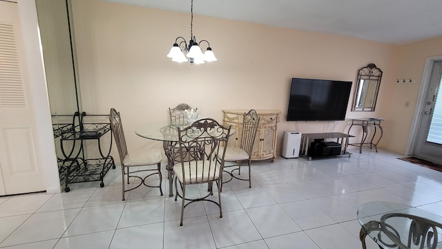 tiled dining area featuring a chandelier