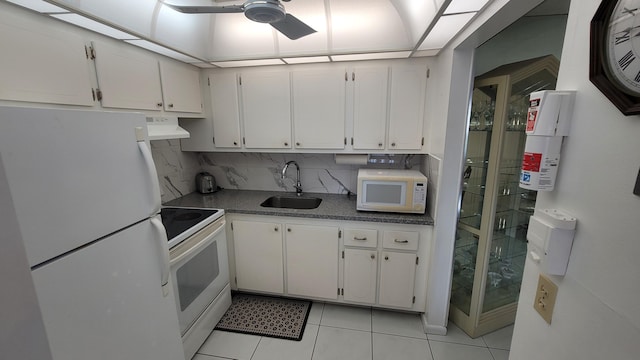 kitchen with white appliances, ventilation hood, sink, light tile patterned floors, and white cabinetry