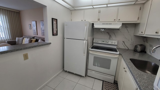 kitchen with white appliances, white cabinets, sink, light tile patterned floors, and tasteful backsplash