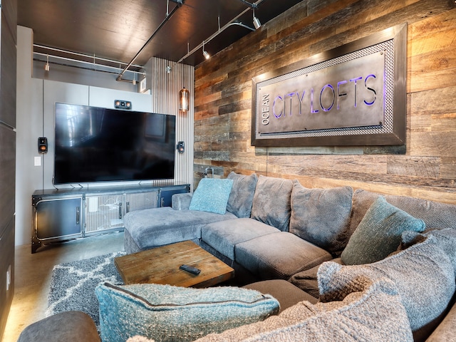 living room with concrete flooring and wood walls