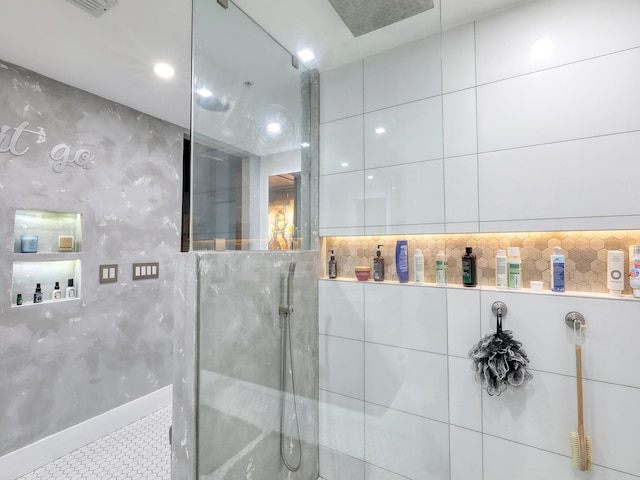 bathroom featuring a shower and tile walls