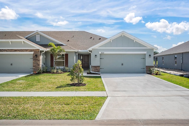 view of front of home with a front yard and a garage