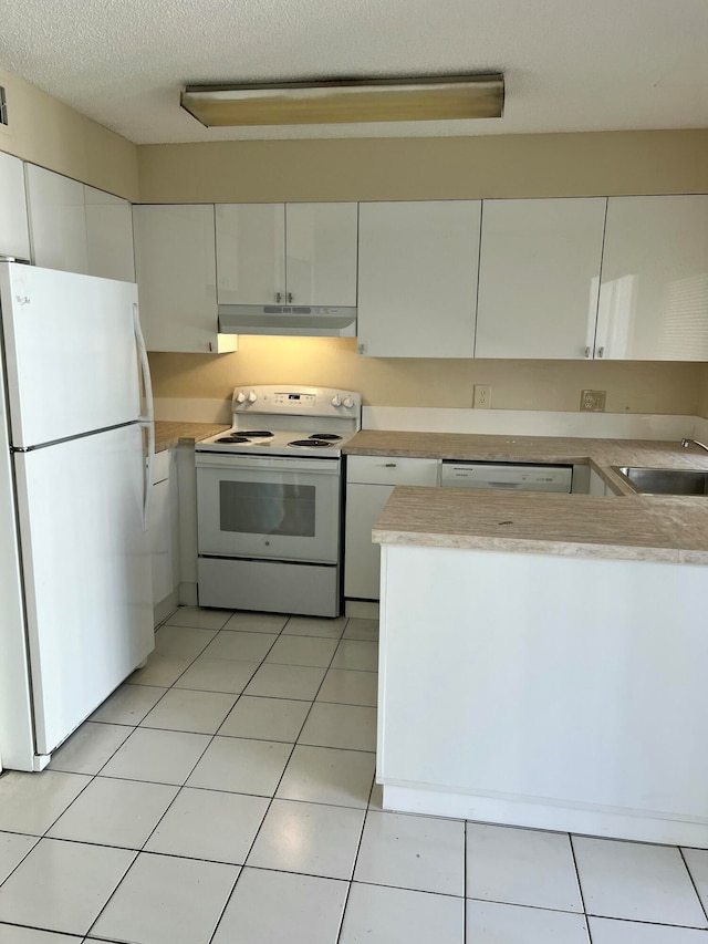 kitchen featuring a textured ceiling, white appliances, white cabinetry, and sink