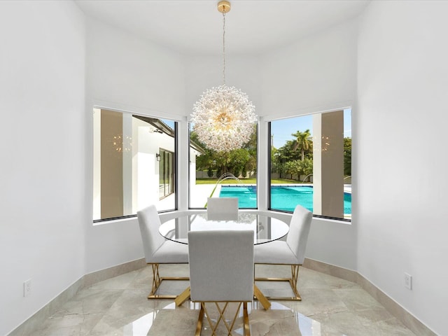 dining room featuring baseboards, marble finish floor, and a chandelier