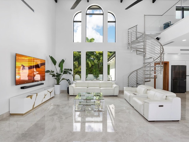 living room featuring a high ceiling and ceiling fan