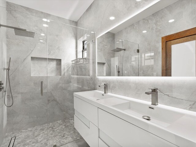 bathroom featuring vanity, tile walls, and independent shower and bath