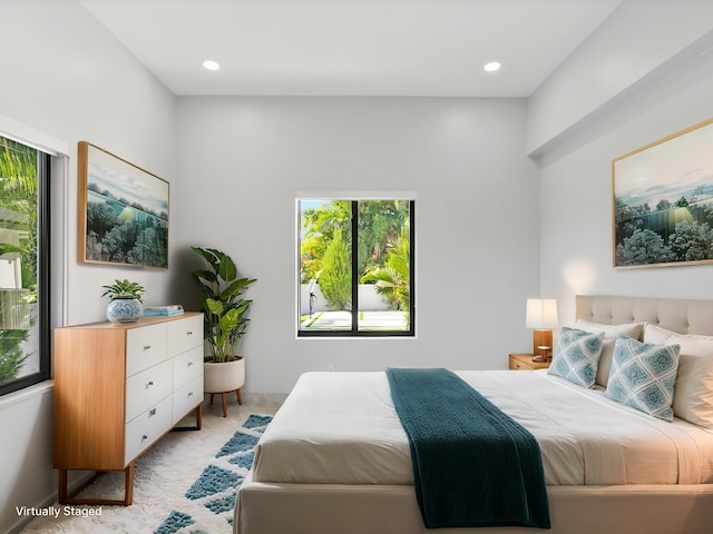 bedroom with recessed lighting and light carpet