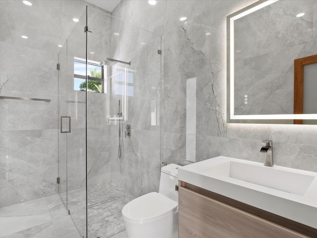 bathroom featuring vanity, tile walls, toilet, and a marble finish shower