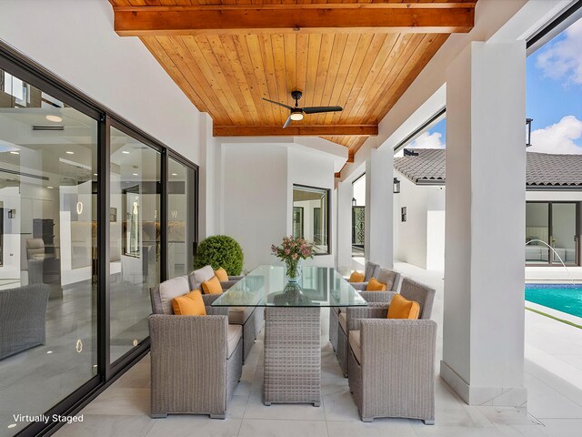 pool at dusk with a patio area and pool water feature