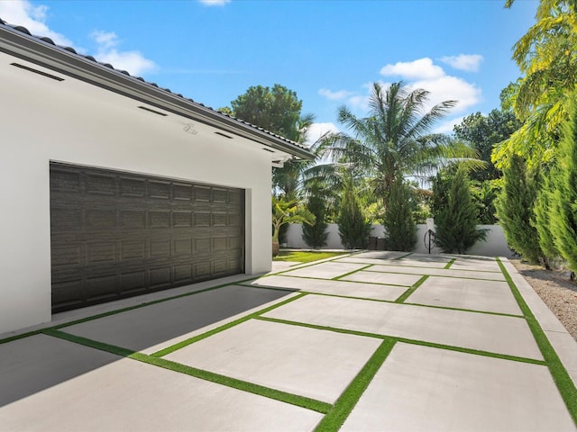 exterior space featuring a garage and fence