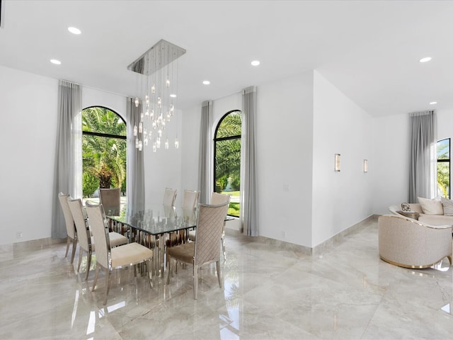 unfurnished dining area with plenty of natural light and a chandelier