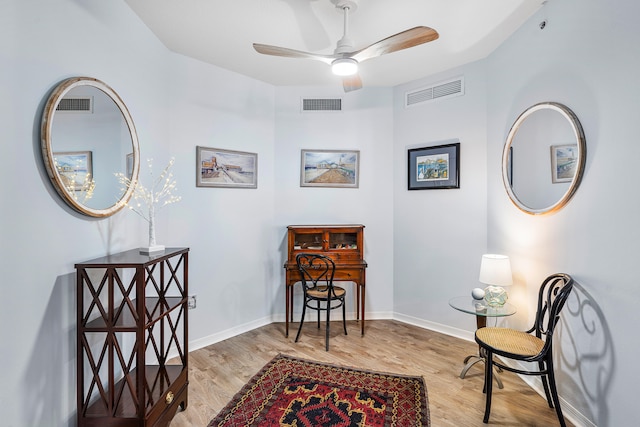 living area featuring light wood-type flooring and ceiling fan