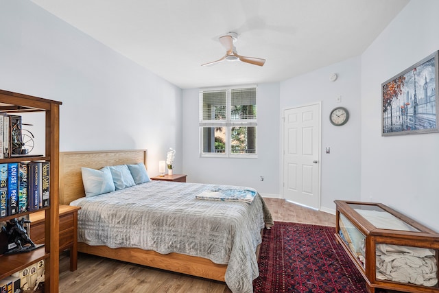 bedroom with ceiling fan and light hardwood / wood-style flooring