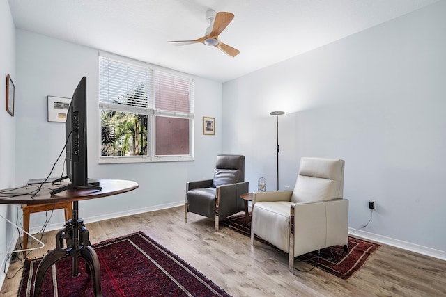 living area featuring ceiling fan and light hardwood / wood-style flooring