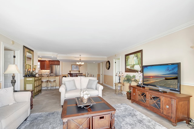 living room with crown molding, light tile patterned floors, and a chandelier