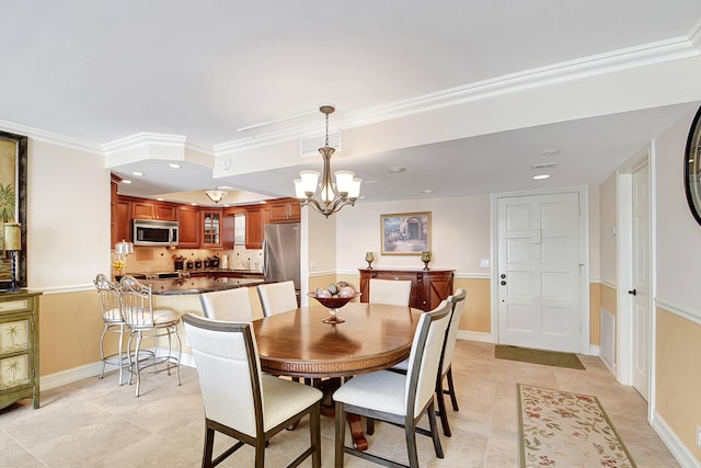 tiled dining room with ornamental molding and a notable chandelier