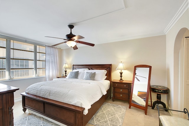 bedroom with ceiling fan and crown molding