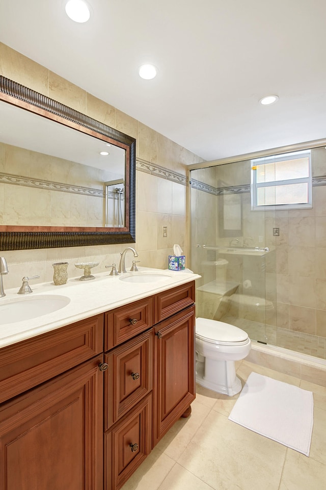 bathroom featuring vanity, tile patterned floors, toilet, tile walls, and walk in shower