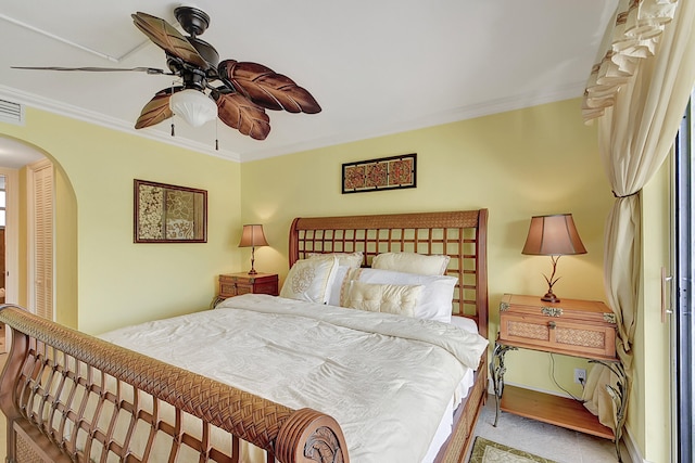 bedroom with ceiling fan, carpet floors, and crown molding