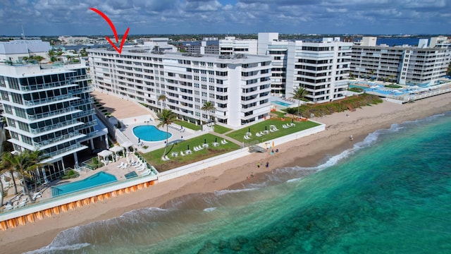 bird's eye view featuring a water view and a view of the beach