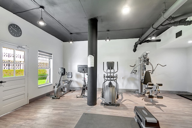 workout area with light hardwood / wood-style flooring