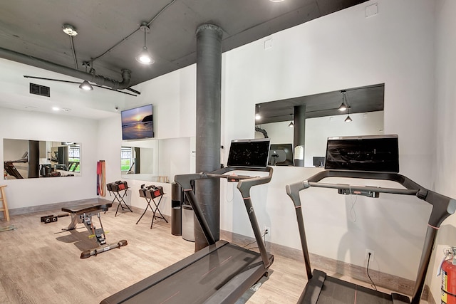 workout area with light wood-type flooring