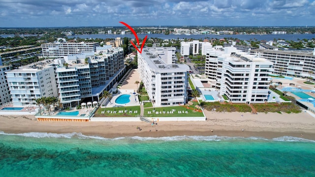 drone / aerial view featuring a view of the beach and a water view