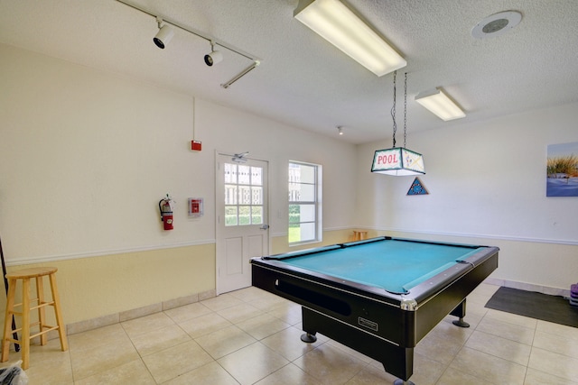 recreation room with light tile patterned floors, a textured ceiling, track lighting, and billiards