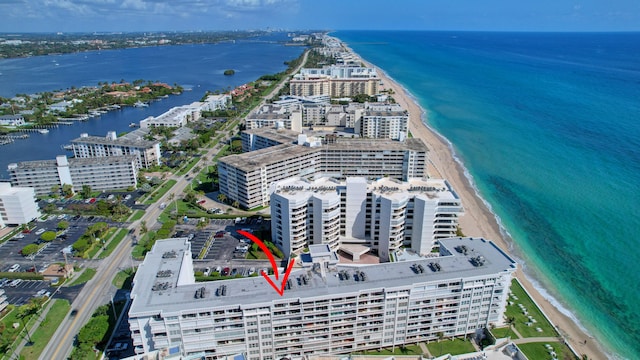 bird's eye view featuring a water view and a view of the beach