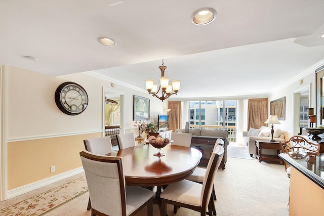 dining area with ornamental molding and a notable chandelier