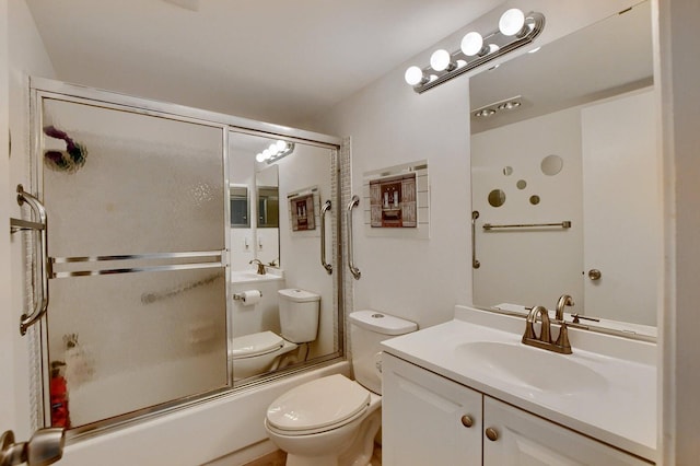 full bathroom with vanity, bath / shower combo with glass door, and toilet