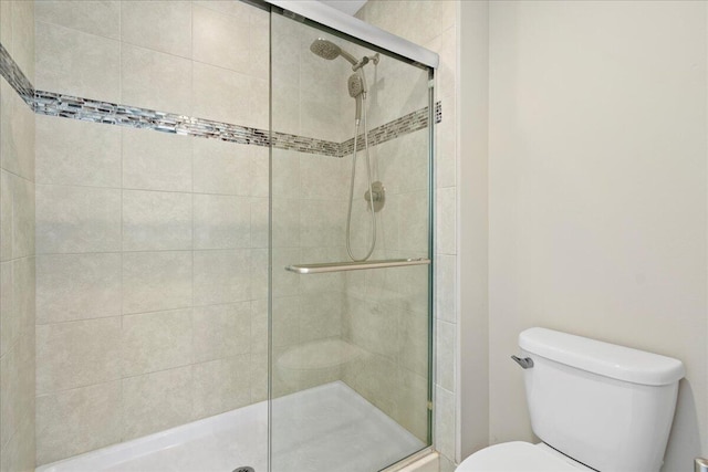 bathroom with toilet and walk in shower