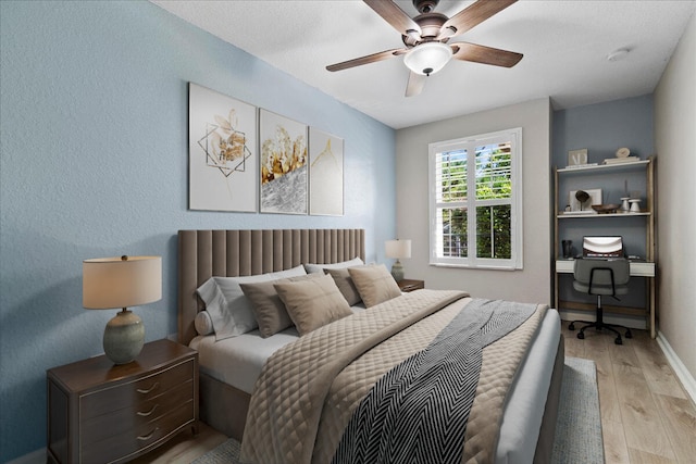 bedroom with ceiling fan and light wood-type flooring