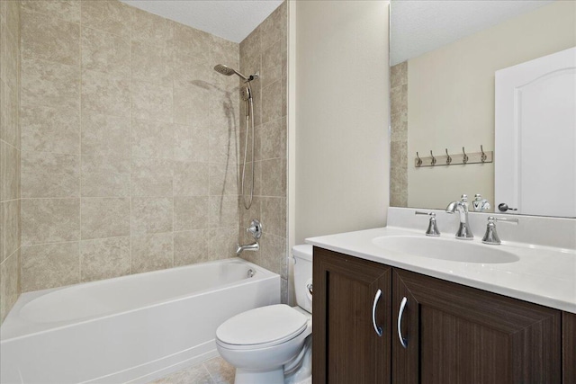 full bathroom with vanity, toilet, a textured ceiling, and tiled shower / bath combo