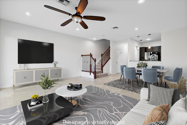 living room with ceiling fan and light tile patterned floors