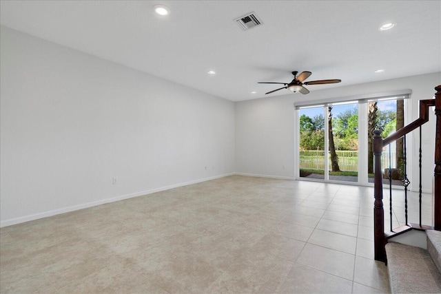 tiled spare room with ceiling fan