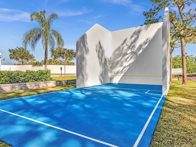 exterior space with fence and a lawn