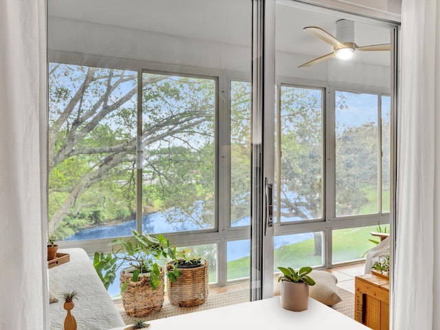 sunroom / solarium with a ceiling fan