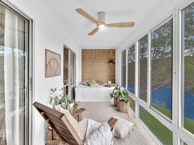 sunroom / solarium featuring a healthy amount of sunlight and a ceiling fan