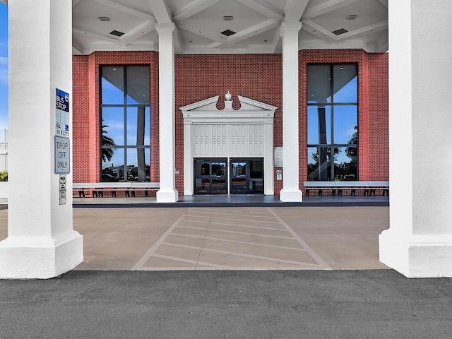 doorway to property with brick siding