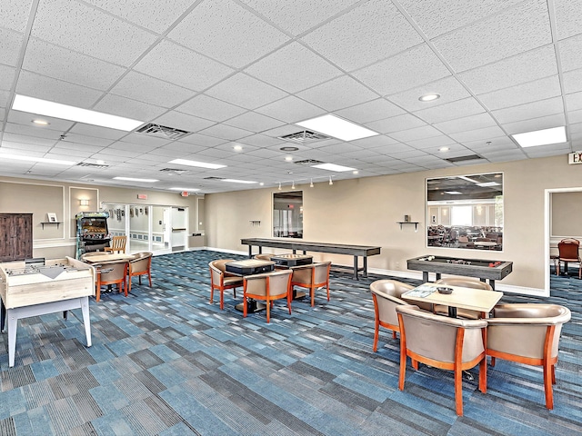 carpeted dining space with a drop ceiling, visible vents, and baseboards