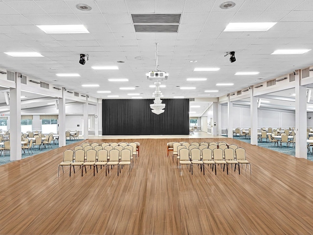 dining space with a drop ceiling, visible vents, and wood finished floors