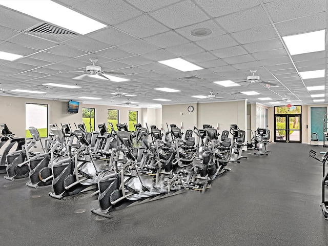 workout area with visible vents, a wealth of natural light, and ceiling fan