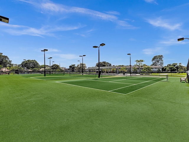 view of tennis court featuring fence