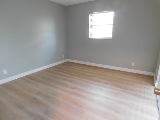 spare room featuring light wood-type flooring