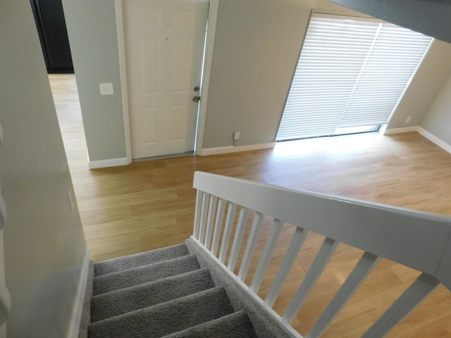 stairs featuring wood-type flooring