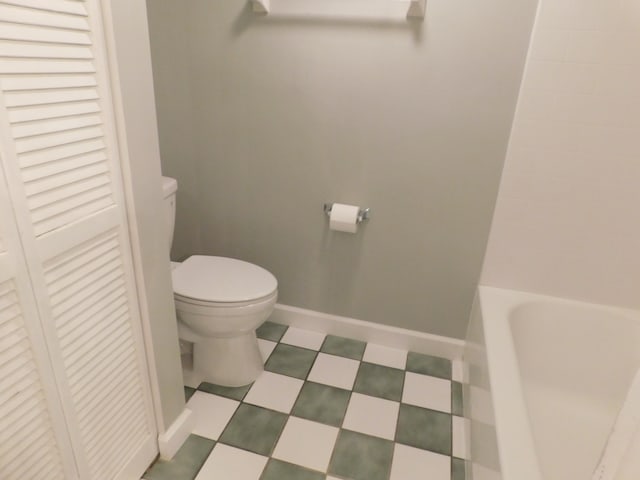 bathroom featuring a bathing tub and toilet