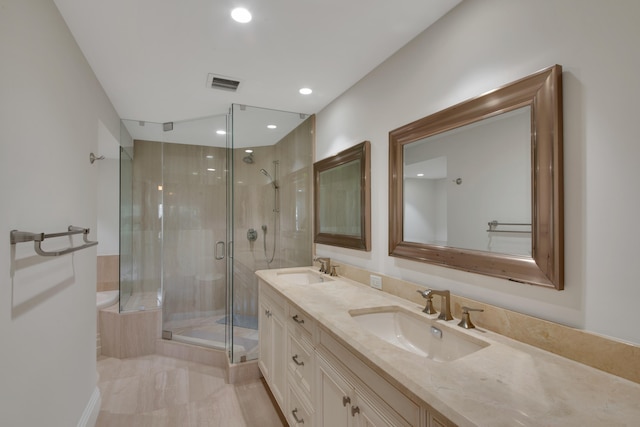 bathroom with a shower with door and vanity