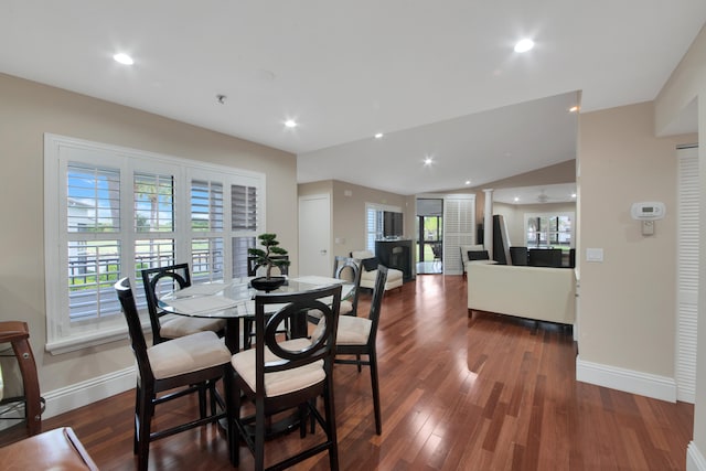 dining room with dark hardwood / wood-style floors, ceiling fan, and lofted ceiling