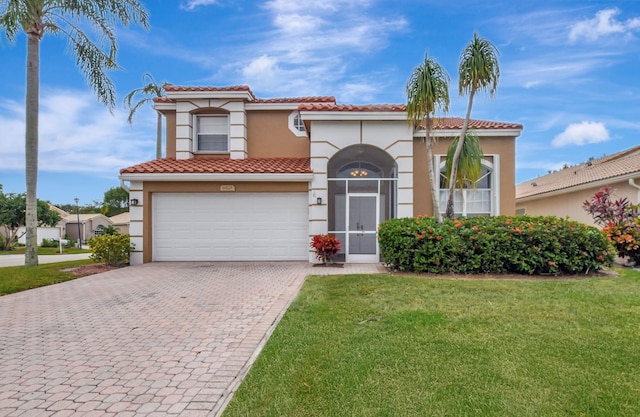 mediterranean / spanish-style house featuring a garage and a front yard